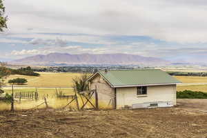 View of mountain backdrop featuring rural landscape