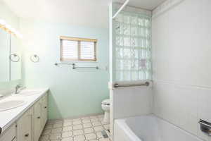 Bathroom featuring a garden tub and double vanity