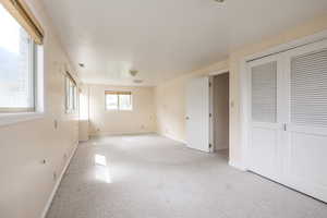 Unfurnished bedroom featuring carpet flooring and baseboards