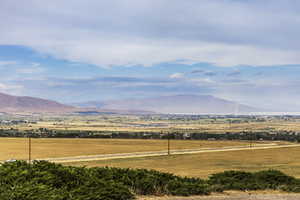 View of mountain backdrop with rural landscape