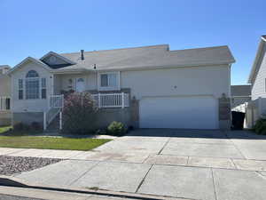 Single story home featuring driveway, a garage, and roof with shingles