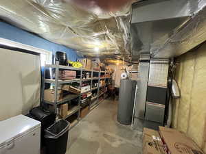 Unfinished below grade area with water heater and heating unit