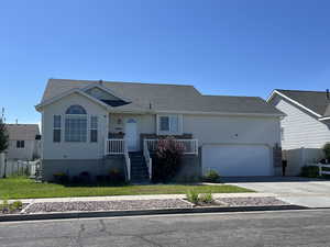 Ranch-style home featuring concrete driveway and a garage