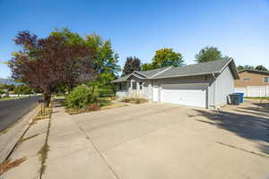 Front and side view of the house with lots of additional parking