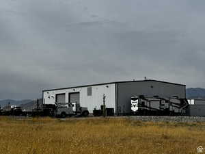 View of pole building with a mountain view