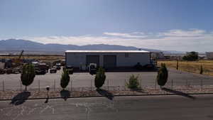 View of front of house with a mountain view and a garage