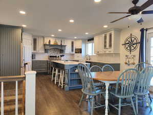 Your kitchen and dining area with lots of lighting, open floor plan, and plenty of seating