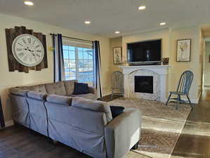 Living room with lots of seating, a fantastic view of the lake, recessed lighting, and a premium fireplace.