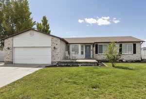 Rambler with beautiful brick, two car garage, and large front yard.