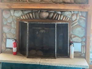 Detailed view of a fireplace and a fire extinguisher