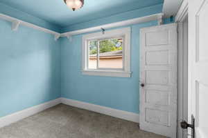 Carpeted spare room with baseboards