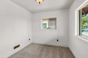 Carpeted empty room with baseboards