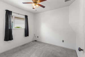 Unfurnished room with carpet floors and ceiling fan