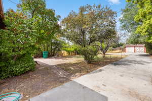 View of yard featuring an outbuilding and a garage