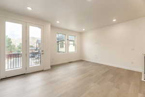 Bright, open living room with large windows and seamless flow—perfect for city living and entertaining.