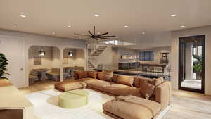 Living room featuring light wood-style floors, recessed lighting, stairs, a ceiling fan, and arched walkways