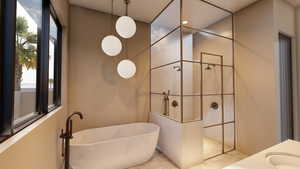 Full bath featuring a freestanding tub, a walk in shower, and vanity