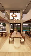 Dining area with a high ceiling, light wood-type flooring, recessed lighting, and healthy amount of natural light