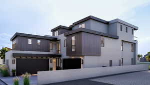 Contemporary home with an attached garage and stucco siding