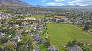 Aerial view of property's location with nearby suburban area and a mountainous background