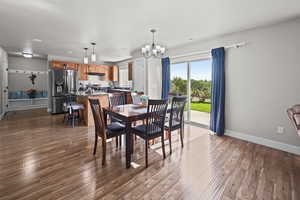 Dining room featuring a chandelier, dark wood-style floors, and recessed lighting