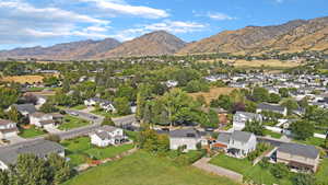 Aerial overview of property's location with nearby suburban area and a mountain backdrop