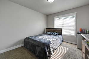 Carpeted bedroom featuring baseboards