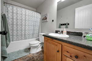 Spare Bathroom with shower / bath combination with curtain and vanity