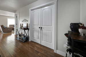 Entrance corridor with dark wood finished floors and baseboards