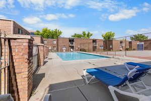 Community pool featuring a patio