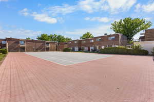 View of tennis court featuring community basketball court