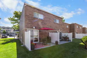 Back of property featuring brick siding