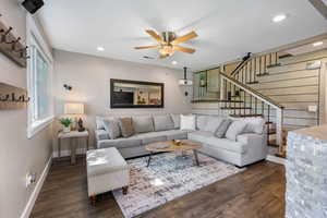 Living area featuring stairway, ceiling fan, dark wood-style floors, and recessed lighting