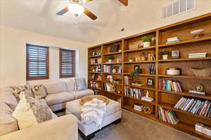 Sitting room with beam ceiling, carpet flooring, a ceiling fan, and high vaulted ceiling
