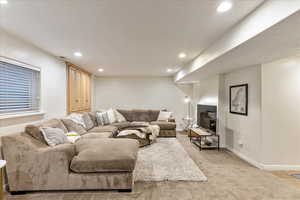 Living room with recessed lighting and light carpet