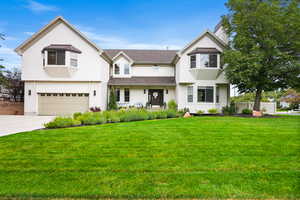 View of front of house featuring a standing seam roof, a garage, and a metal roof