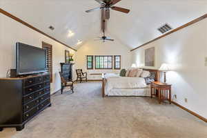 Bedroom with light colored carpet, high vaulted ceiling, crown molding, beam ceiling, and ceiling fan