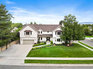 Modern farmhouse featuring driveway, stucco siding, a garage, and roof with shingles