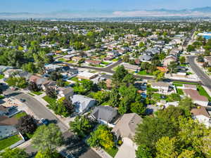 Aerial view of property and surrounding area with nearby suburban area