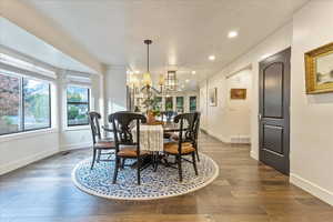 Dining area featuring recessed lighting, hardwood / wood-style flooring, a textured ceiling, and a chandelier