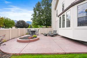 Fenced backyard with a patio area, a mountain view, and outdoor dining area