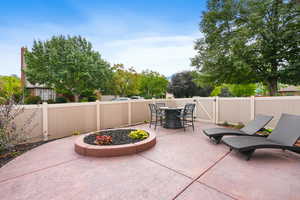 Fenced backyard featuring outdoor dining area, a patio, and a gate
