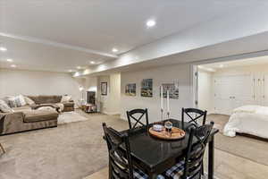 Dining area with recessed lighting and light colored carpet