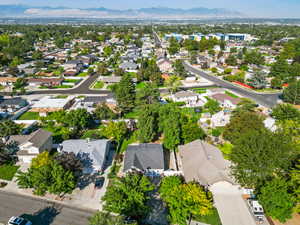 Aerial overview of property's location with a mountainous background and nearby suburban area