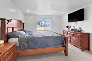 Bedroom featuring light colored carpet