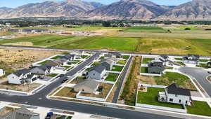 View of rural area with a mountainous background and nearby suburban area