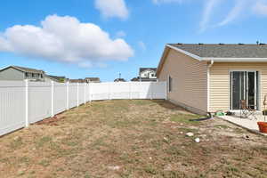 Fenced backyard featuring a patio area