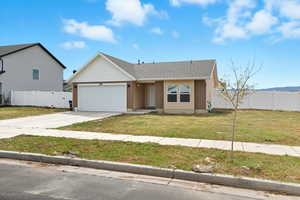 View of front of home with driveway, an attached garage, and roof with shingles
