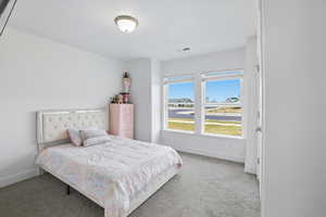 Carpeted bedroom featuring baseboards