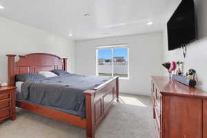 Bedroom featuring light colored carpet and recessed lighting
